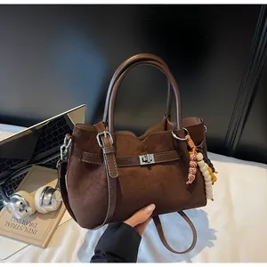 Elegant vintage brown suede tote bag featuring decorative bead tassel and shoulder strap