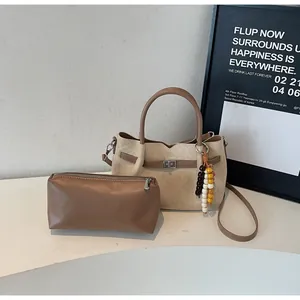Elegant beige suede tote bag with brown leather accents and matching vanity pouch set