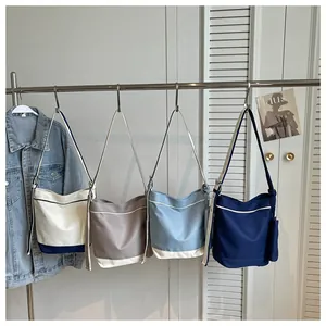Collection of Korean style contrast canvas tote bags in four colors hanging on a rack