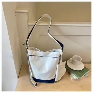 Modern contrast color canvas tote bag with side pouch and large capacity design.