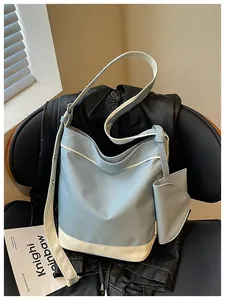 Detail view of a stylish contrast canvas tote bag on a chair with lifestyle props.
