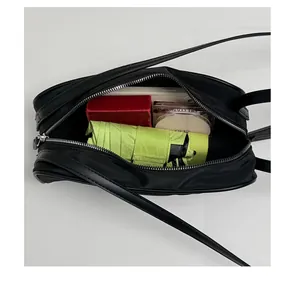 Interior detail of a vintage nylon crossbody bag showing spacious capacity for daily items.