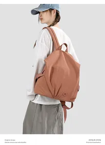 Detailed side view of a brown large capacity nylon backpack for casual travel and school