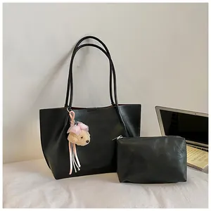 Black large-capacity tote bag with matching pouch and plush bear charm for commuting.