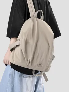 Large capacity beige nylon backpack for women featuring a minimalist and lightweight design.