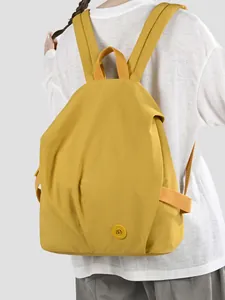 Lightweight yellow nylon backpack for women with minimalist design for daily travel