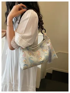 Detailed view of the New Chinese style elephant print handbag with tassel and beads