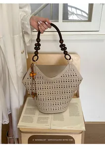 Detailed view of cream laser-cut retro hollow-out tote bag with wooden bead handles