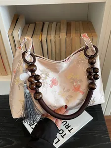 Chinese style floral jacquard handbag with wooden bead handle and tassel charm