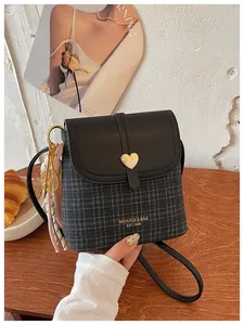 Stylish small women's crossbody bucket bag featuring plaid pattern and gold heart clasp