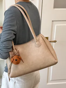 Retro beige tote bag for women with large capacity and cute poodle plush charm accessory.