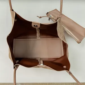Detailed interior view of a large brown suede commuter tote bag with matching pouch