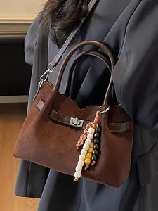 Retro brown suede tote handbag with metal twist-lock and decorative bead tassel