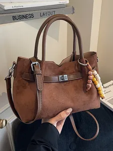 Vintage brown suede handbag with beaded tassel and crossbody strap