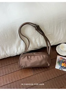 Vintage brown nylon shoulder bag for women displayed elegantly in a cozy room setting