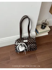 Elegant vintage-style brown polka dot underarm shoulder bag with a cute heart charm detail