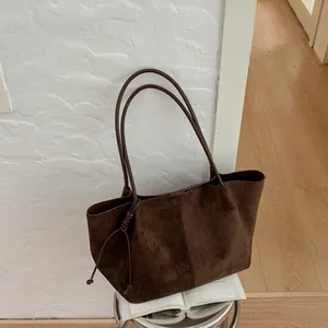 Vintage brown suede tote bag with long shoulder straps for a premium commuter style