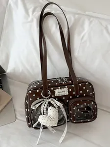 Stylish brown polka dot underarm bag with decorative heart charm and pearl details
