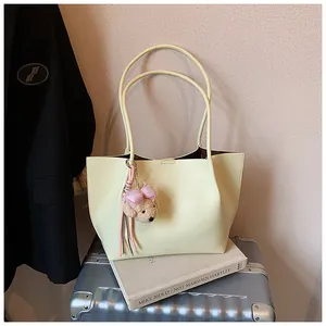 Sophisticated cream-colored commuter tote bag for women with a cute bear charm