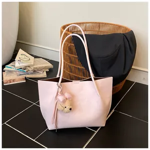 Minimalist pink large capacity tote bag for women featuring a cute plush dog charm