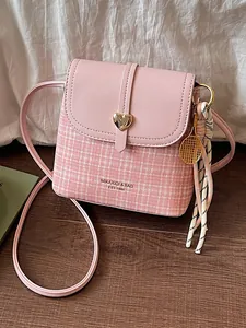 Pink tweed crossbody bag with gold heart buckle and tennis racket charm for women