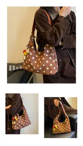 Detailed macro view of retro brown suede polka dot tote bag featuring colorful pom-pom charm