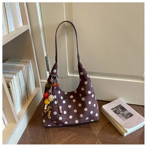 Retro brown suede tote bag with white polka dots and colorful beaded bag charm.