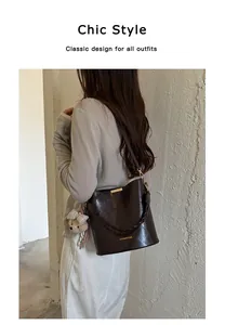 Detailed side view of dark brown faux leather bucket bag on a stylish female model