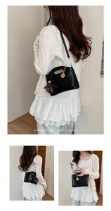 Black minimalist handbag for women, stylish shoulder bag with acorn charm detail