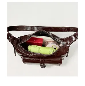 Internal view of brown glossy shoulder bag showing capacity for daily essentials