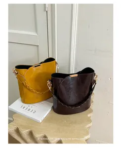 Detailed view of fashionable commuter bucket bags in mustard yellow and coffee brown colors