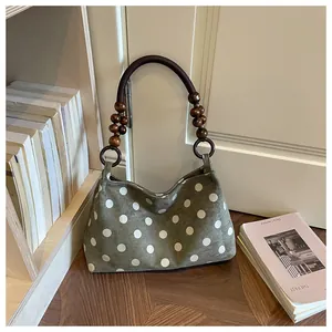 Vintage olive green polka dot shoulder bag with unique wooden bead handle detail