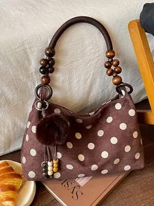 Brown suede shoulder bag with white polka dots and wooden bead handle