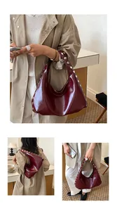 Multiple views of a vintage burgundy hobo bag with silver rivets for office commute.