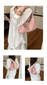 Stylish pink hobo shoulder bag featuring rivet accents and a spacious dumpling design