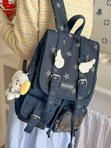 Vintage denim backpack with star patterns and wing details, shown in a lifestyle setting.