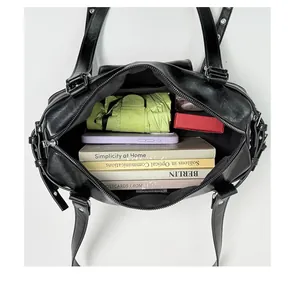 Top-down interior view of a black studded shoulder bag showing its large storage capacity
