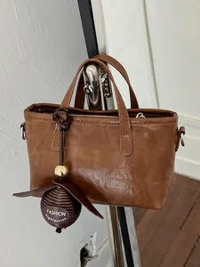 Élégant sac cabas marron en similicuir pour le travail avec une breloque boule décorative