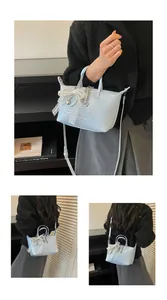 Detailed views of a light blue woven tote bag with a lace bow and crossbody strap.