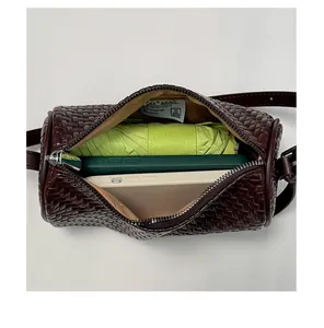 Detailed view showing the interior capacity of this vintage brown woven barrel bag.