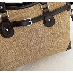 Close-up detail showing the premium woven texture and leather straps of the stylish tote bag.