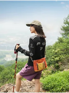 Outdoor lifestyle detail view of fashionable orange canvas crossbody tote bag for women