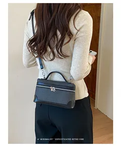 Gedetailleerd overzicht van een verfijnde zwarte vierkante crossbodytas op een model