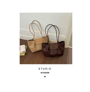 Detail shot of stylish woven textured tote bags on a natural wooden floor background