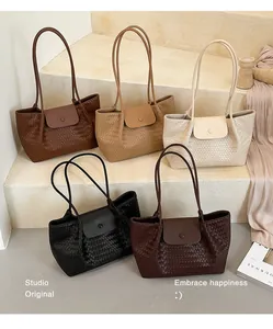 Close-up of high-end woven pattern tote bags available in five elegant neutral colors