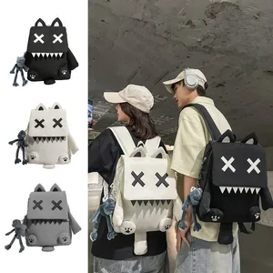 Cute monster canvas backpack with cartoon eyes and frog pendant plush charm