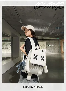 Cute white monster backpack with funny cartoon eyes and teeth on a female model