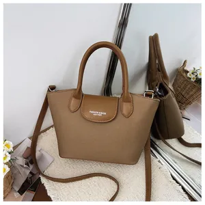 Elegant brown vintage tote bag with leather straps and mirror reflection detail view