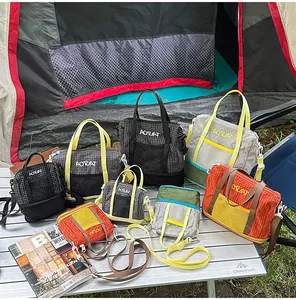 Casual checkered fabric tote and crossbody bags displayed on an outdoor camping table