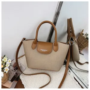 Vintage tote bag with canvas and leather details shown in a stylish home setting